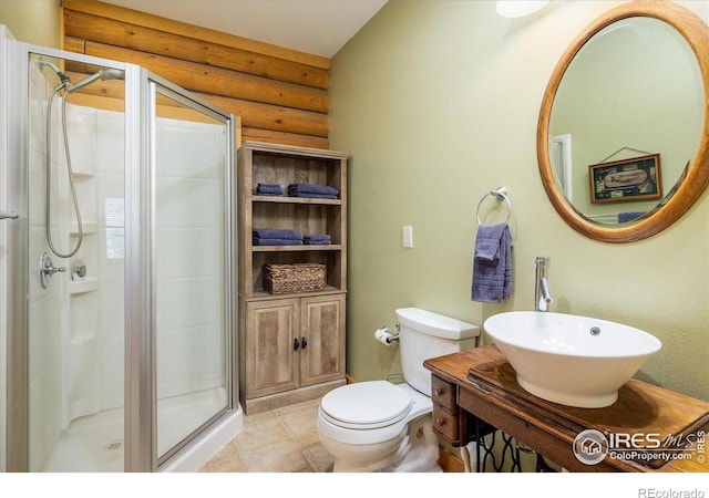 280 Hummer Dr, Nederland, CO 80466 - full bath with a stall shower, log walls, and vanity