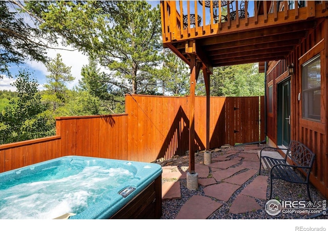280 Hummer Dr, Nederland, CO 80466 - fenced backyard featuring a hot tub and a patio area