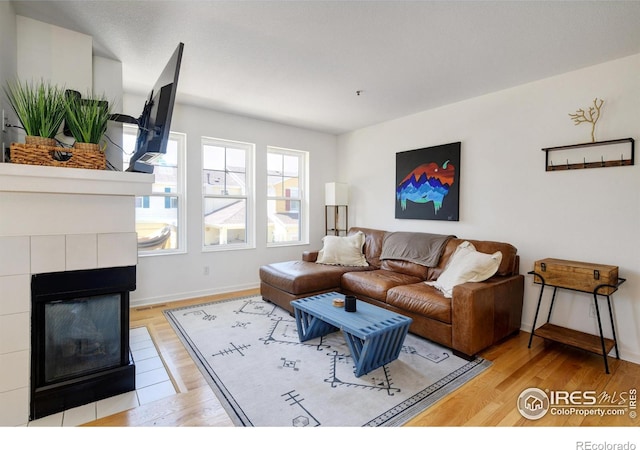 3970 Colorado Ave Unit G, Boulder, CO 80303 - living room featuring light wood-style flooring and a tile fireplace