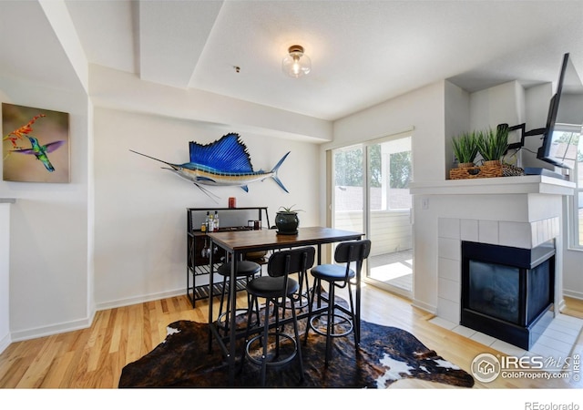 3970 Colorado Ave Unit G, Boulder, CO 80303 - dining room featuring wood finished floors, healthy amount of natural light, and a tiled fireplace