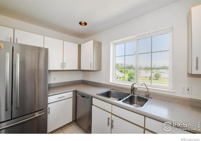 3970 Colorado Ave Unit G, Boulder, CO 80303 - kitchen featuring stainless steel appliances, white cabinets, light countertops, and light tile patterned flooring