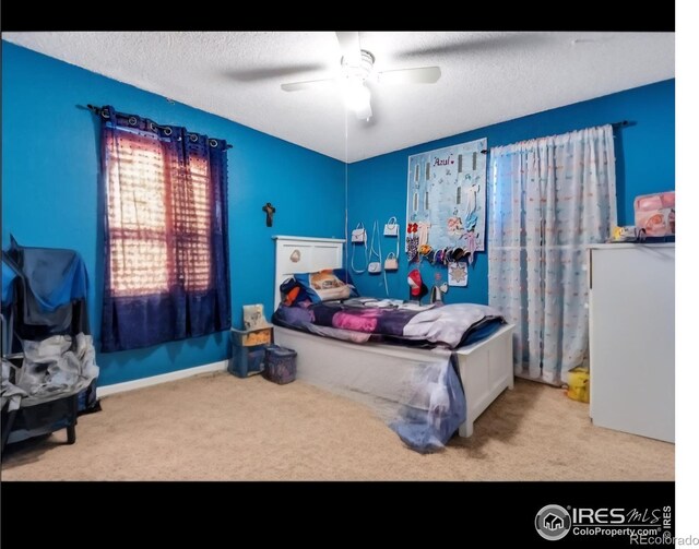 5519 Tucson St, Denver, CO 80239 - bedroom with carpet, ceiling fan, and a textured ceiling