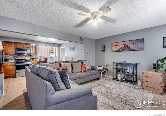 5519 Tucson St, Denver, CO 80239 - living area with a textured ceiling, ceiling fan, and light tile patterned floors