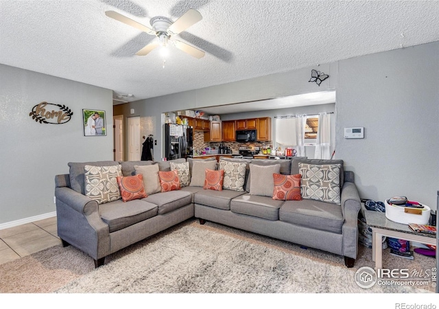 5519 Tucson St, Denver, CO 80239 - living room featuring a textured ceiling, a ceiling fan, and light tile patterned floors