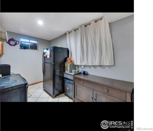 5519 Tucson St, Denver, CO 80239 - kitchen with freestanding refrigerator and light tile patterned floors