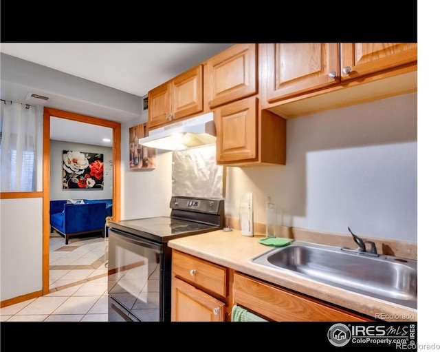 5519 Tucson St, Denver, CO 80239 - kitchen featuring black range with electric stovetop, under cabinet range hood, light tile patterned floors, light brown cabinets, and light countertops