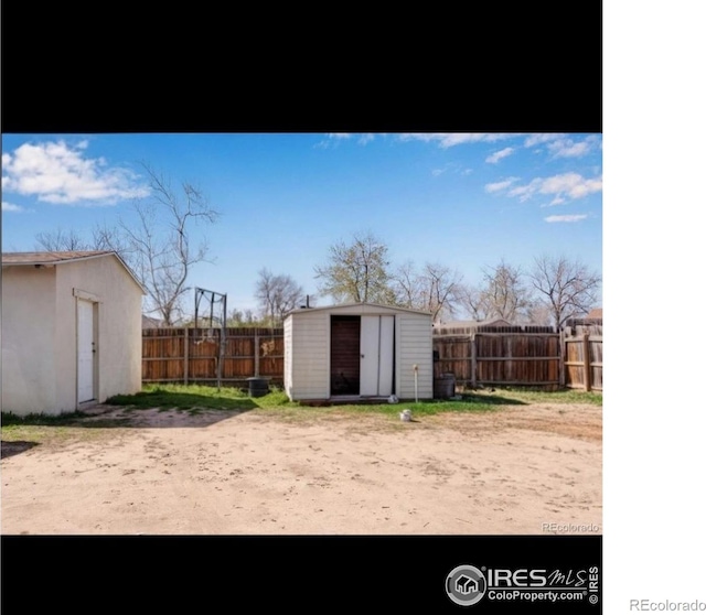 5519 Tucson St, Denver, CO 80239 - fenced backyard featuring a storage shed