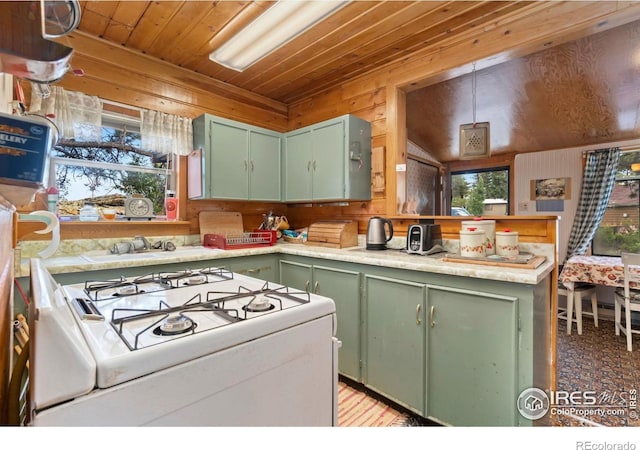 983 Ramona Dr, Red Feather Lakes, CO 80545 - kitchen featuring green cabinetry, white gas stove, wood ceiling, wood walls, and light countertops