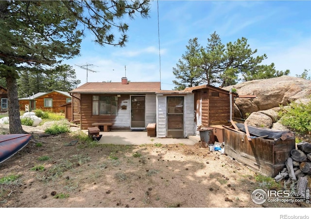 983 Ramona Dr, Red Feather Lakes, CO 80545 - view of front facade with a patio area and a chimney