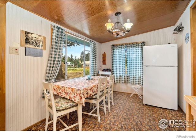 983 Ramona Dr, Red Feather Lakes, CO 80545 - dining space with a chandelier and vaulted ceiling