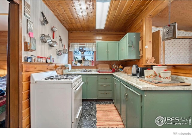 983 Ramona Dr, Red Feather Lakes, CO 80545 - kitchen featuring white range with gas stovetop, green cabinets, light countertops, wooden walls, and wooden ceiling