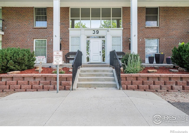 39 Ward Dr Unit 202, Greeley, CO 80634 - property entrance featuring a porch and brick siding
