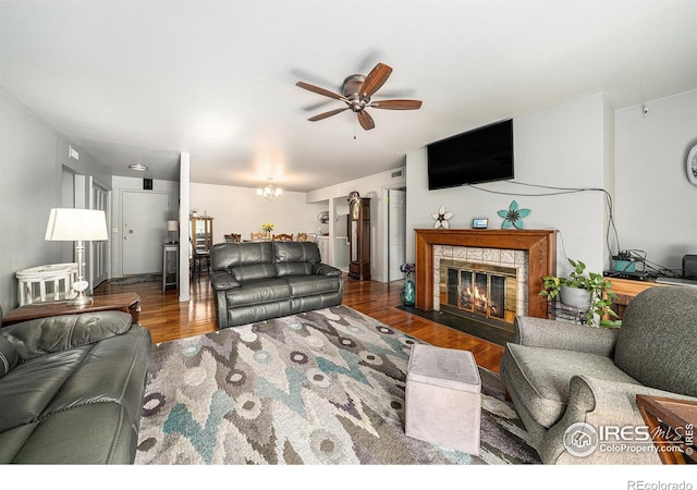 39 Ward Dr Unit 202, Greeley, CO 80634 - living area with ceiling fan, wood finished floors, a tiled fireplace, and a chandelier