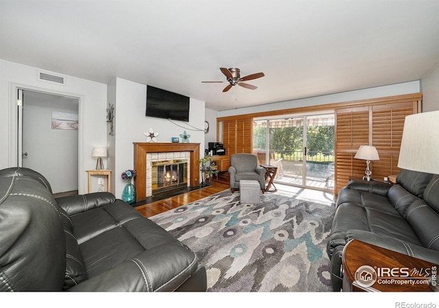 39 Ward Dr Unit 202, Greeley, CO 80634 - living room with a ceiling fan, wood finished floors, and a tile fireplace