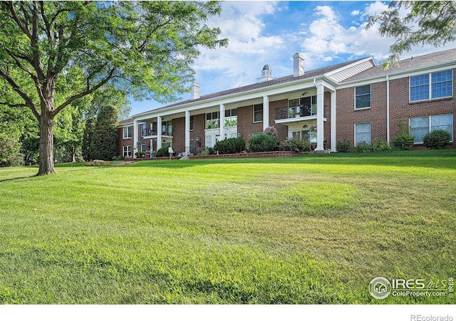 39 Ward Dr Unit 202, Greeley, CO 80634 - split foyer home with brick siding, a front lawn, and a chimney
