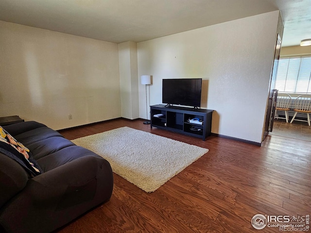 1402 Fillmore St, Sterling, CO 80751 - living room featuring baseboards and wood finished floors