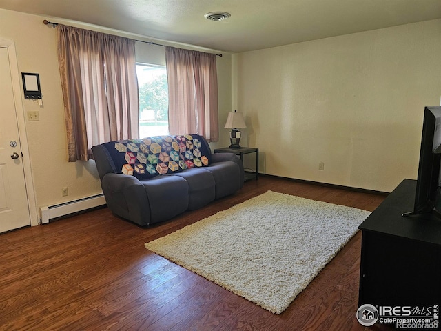 1402 Fillmore St, Sterling, CO 80751 - living room featuring a baseboard radiator and dark wood finished floors
