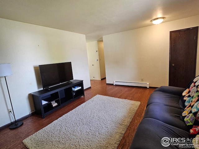 1402 Fillmore St, Sterling, CO 80751 - living area featuring a baseboard heating unit and wood finished floors