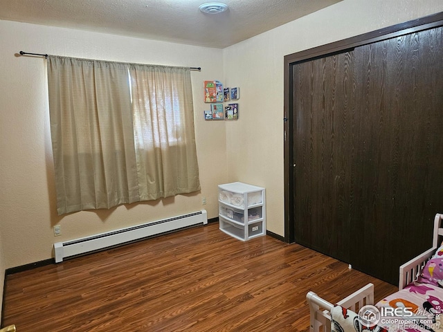 1402 Fillmore St, Sterling, CO 80751 - bedroom with a baseboard radiator and wood finished floors