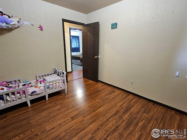 1402 Fillmore St, Sterling, CO 80751 - bedroom featuring wood finished floors and baseboards