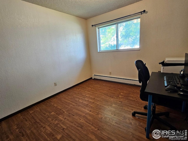 1402 Fillmore St, Sterling, CO 80751 - office space with a baseboard radiator, wood finished floors, a textured ceiling, and a textured wall