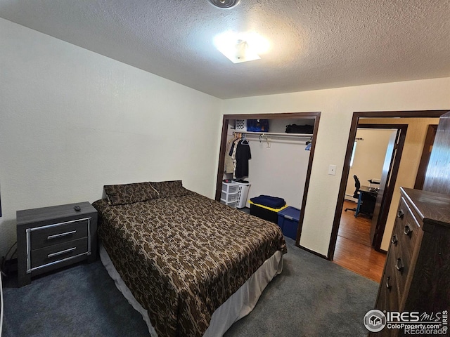 1402 Fillmore St, Sterling, CO 80751 - bedroom with dark carpet, a closet, and a textured ceiling