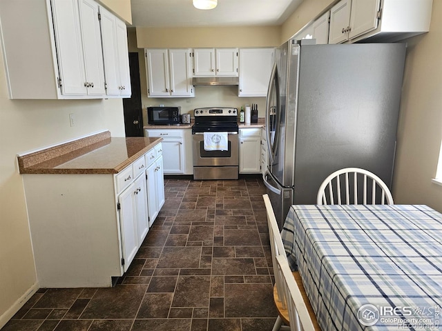 1402 Fillmore St, Sterling, CO 80751 - kitchen featuring appliances with stainless steel finishes, under cabinet range hood, stone tile flooring, and white cabinets