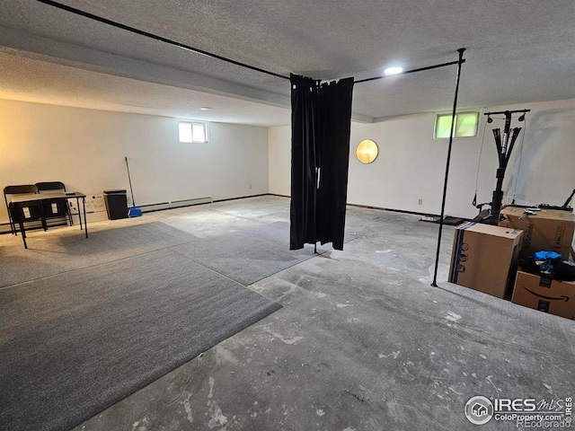 1402 Fillmore St, Sterling, CO 80751 - below grade area with a baseboard heating unit and a textured ceiling