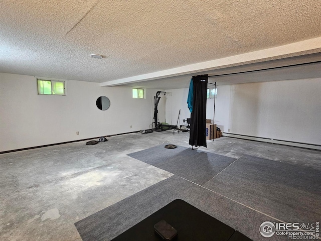 1402 Fillmore St, Sterling, CO 80751 - exercise area with a baseboard radiator and a textured ceiling