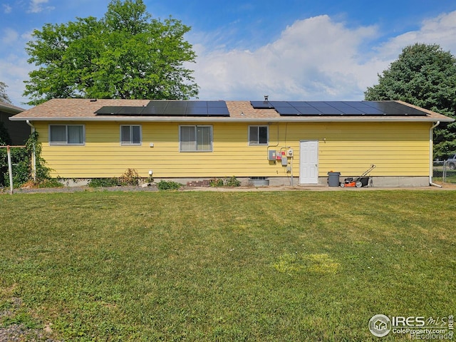 1402 Fillmore St, Sterling, CO 80751 - back of property with a yard and roof mounted solar panels