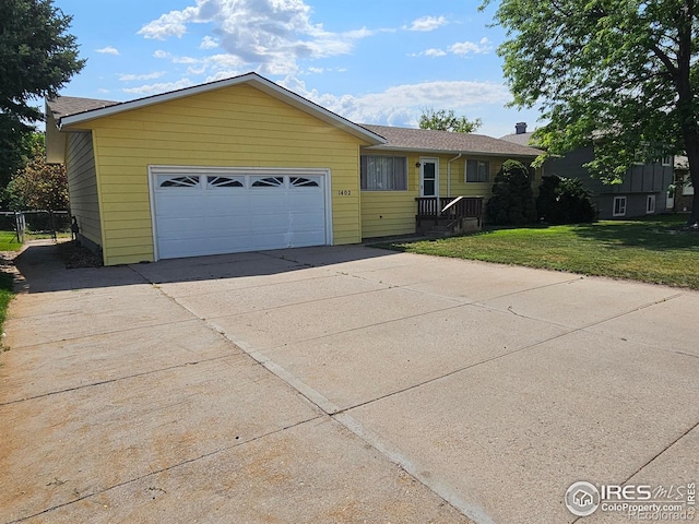 1402 Fillmore St, Sterling, CO 80751 - single story home featuring concrete driveway, a front lawn, and a garage