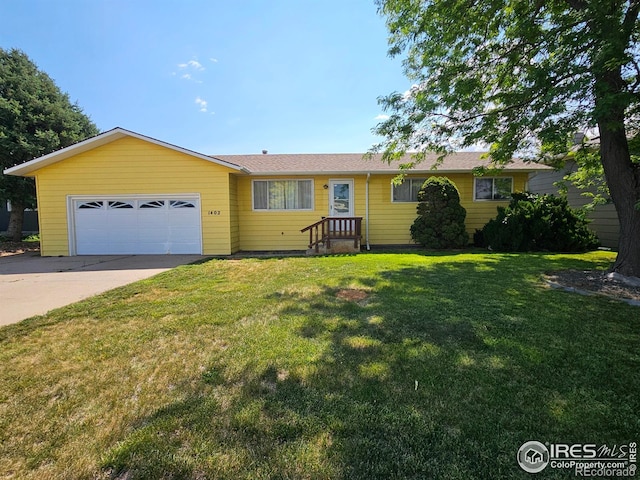 1402 Fillmore St, Sterling, CO 80751 - single story home featuring an attached garage, driveway, and a front yard