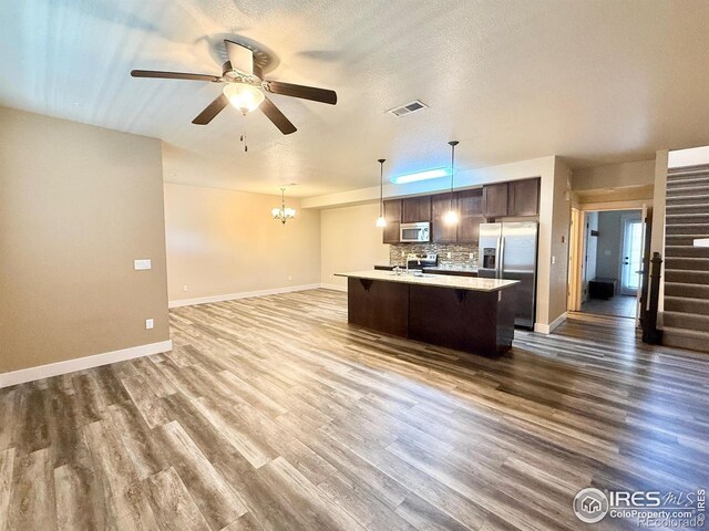 2110 Nancy Gray Ave, Fort Collins, CO 80525 - kitchen featuring stainless steel appliances, open floor plan, dark brown cabinets, light countertops, and a ceiling fan