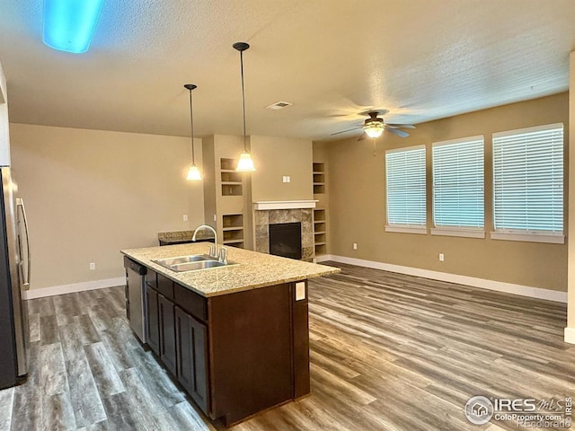 2110 Nancy Gray Ave, Fort Collins, CO 80525 - kitchen with stainless steel appliances, ceiling fan, dark wood-style floors, dark brown cabinets, and an island with sink