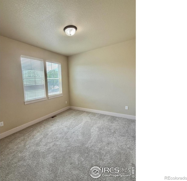 2110 Nancy Gray Ave, Fort Collins, CO 80525 - carpeted spare room with a textured ceiling and baseboards