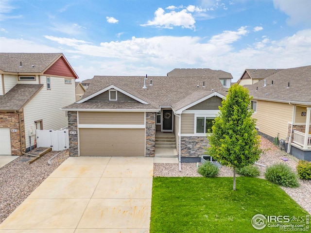 619 Rosedale St, Severance, CO 80550 - craftsman-style home with driveway, an attached garage, a shingled roof, stone siding, and a gate