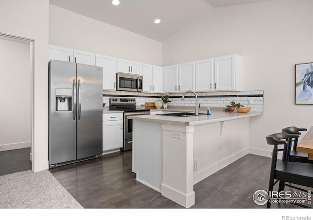 619 Rosedale St, Severance, CO 80550 - kitchen featuring appliances with stainless steel finishes, decorative backsplash, light countertops, white cabinets, and high vaulted ceiling