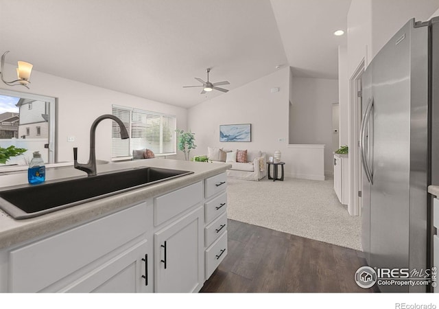 619 Rosedale St, Severance, CO 80550 - kitchen with freestanding refrigerator, vaulted ceiling, a ceiling fan, dark wood-style floors, and white cabinets