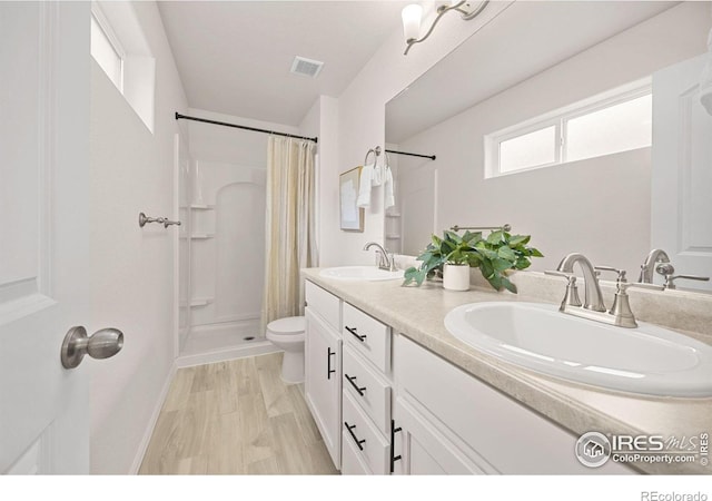 619 Rosedale St, Severance, CO 80550 - full bath with a shower with curtain, double vanity, and wood finished floors