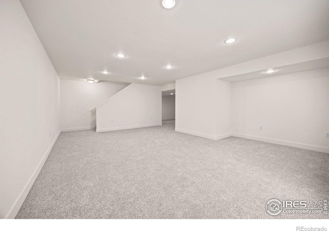 619 Rosedale St, Severance, CO 80550 - finished basement featuring recessed lighting, light carpet, and stairway