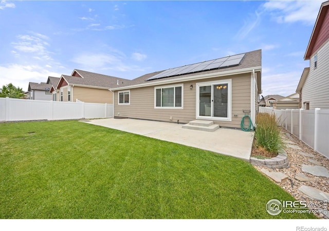 619 Rosedale St, Severance, CO 80550 - rear view of property with a patio area, roof mounted solar panels, and a fenced backyard