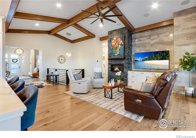 4198 Prestwich Ct, Timnath, CO 80547 - living area featuring light wood-type flooring, ceiling fan, and a large fireplace