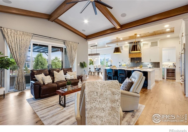 4198 Prestwich Ct, Timnath, CO 80547 - living room featuring wine cooler, a ceiling fan, light wood-style flooring, and recessed lighting