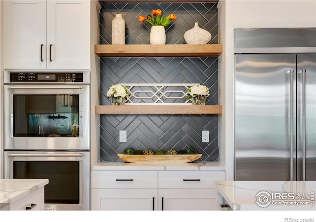 4198 Prestwich Ct, Timnath, CO 80547 - kitchen with stainless steel appliances, open shelves, white cabinetry, and backsplash