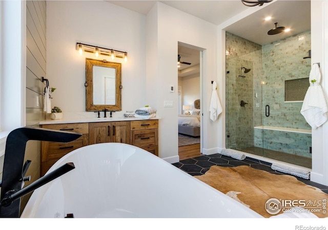 4198 Prestwich Ct, Timnath, CO 80547 - ensuite bathroom with a freestanding bath, a stall shower, ceiling fan, vanity, and tile patterned flooring