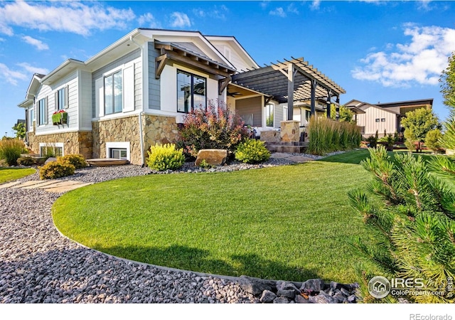 4198 Prestwich Ct, Timnath, CO 80547 - view of front facade featuring stone siding, a pergola, and a front lawn