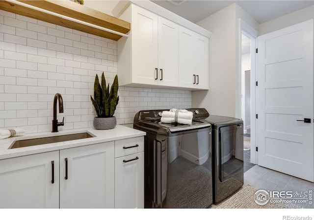 4198 Prestwich Ct, Timnath, CO 80547 - washroom featuring cabinet space, separate washer and dryer, and light tile patterned floors