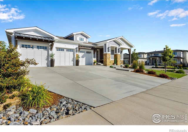 4198 Prestwich Ct, Timnath, CO 80547 - craftsman-style house featuring an attached garage, concrete driveway, and a standing seam roof
