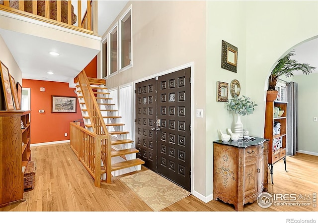 1470 71st Ave, Greeley, CO 80634 - entryway with a high ceiling, wood finished floors, stairway, arched walkways, and recessed lighting