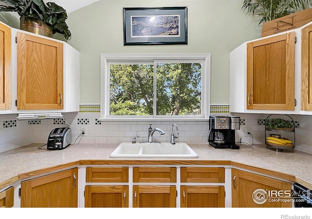 1470 71st Ave, Greeley, CO 80634 - kitchen with light countertops, tasteful backsplash, and vaulted ceiling